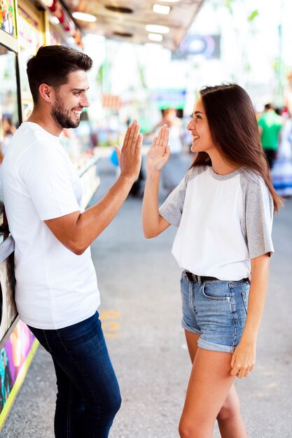 Mid shot couple high fiving