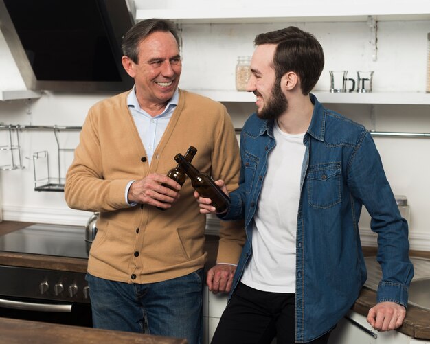 Mid shot father and son enjoying drinks