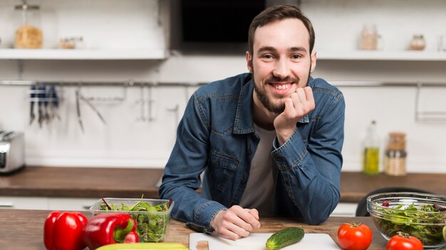 Mid shot male smiling in kitchen