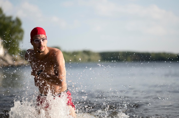 Mid shot man running in lake