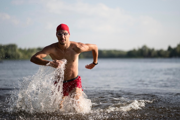 Mid shot swimmer running in lake