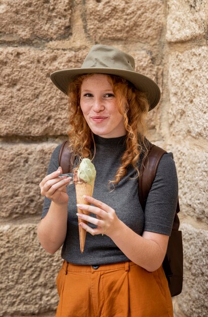 Mid shot woman eating ice cream cone