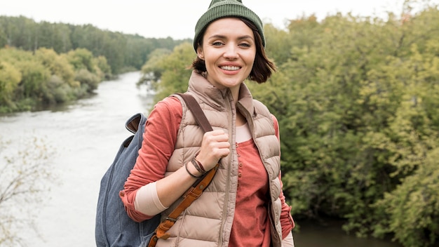 Free Photo mid shot woman posing in front of river