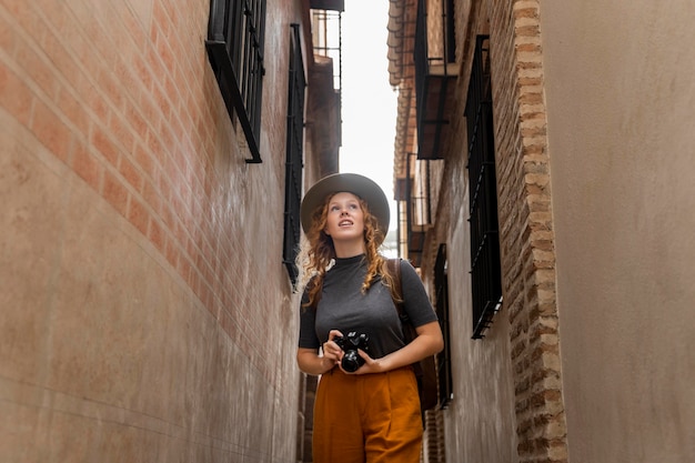 Free Photo mid shot woman with hat and camera