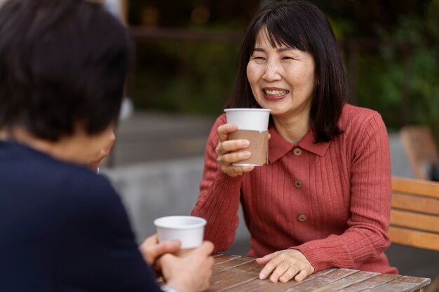 Middle age friends having fun at coffee shop