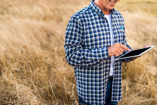 Free Photo middle age man holding a tablet