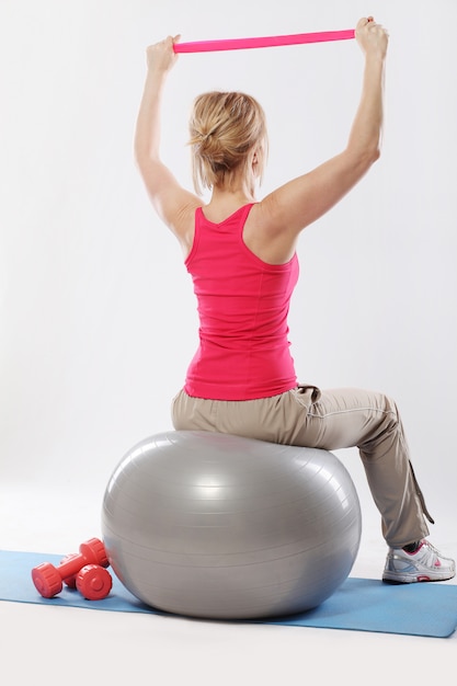 middle age woman working out with ball