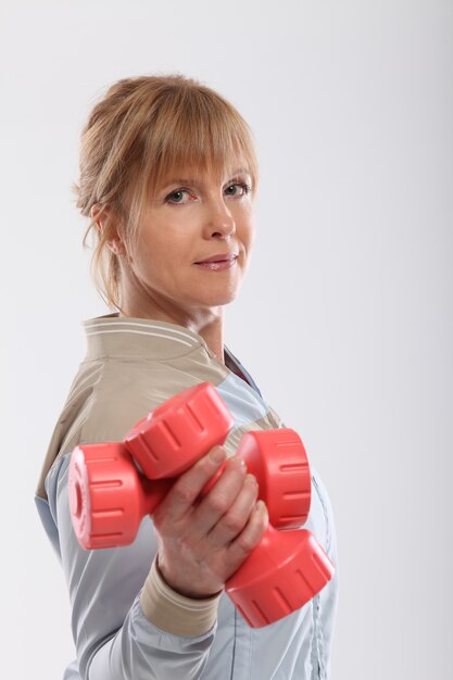 middle age woman working out with dumbbells