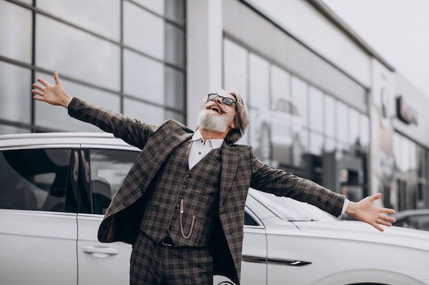 Free photo middle aged business man in a car salon