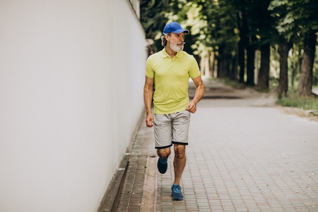 Free photo middle aged man jogging in park