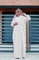 Free photo middle eastern arab man posed on street against modern building