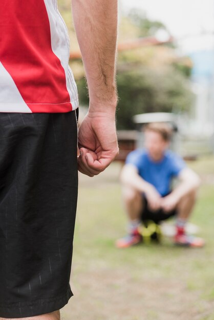 Midsection of a sportsman standing on ground