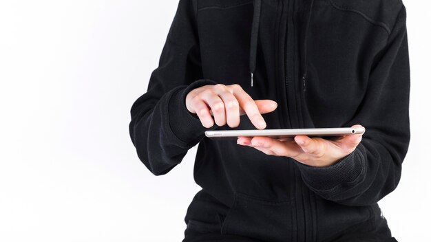 Midsection view of a person's hand using digital tablet