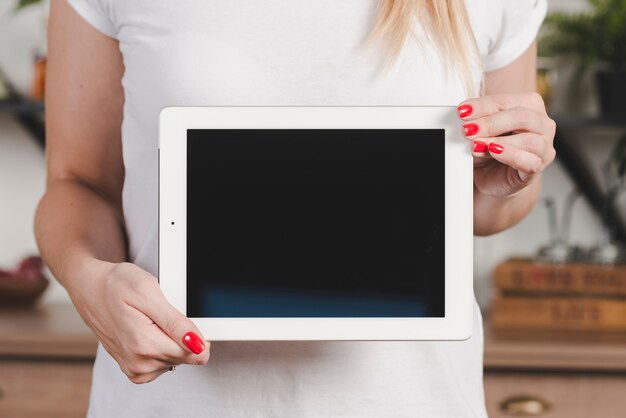 Midsection of woman's hand showing blank digital tablet screen