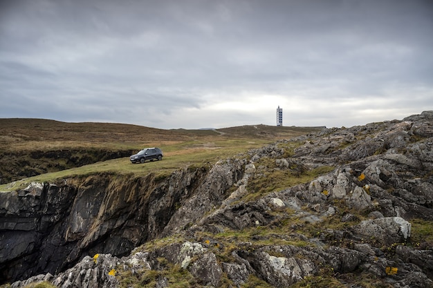 Mieras lighthouse on the Valdovino cliffs under a cloudy sky in Galicia, Spain