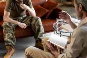 Free photo military man suffering from ptsd having psychologist session