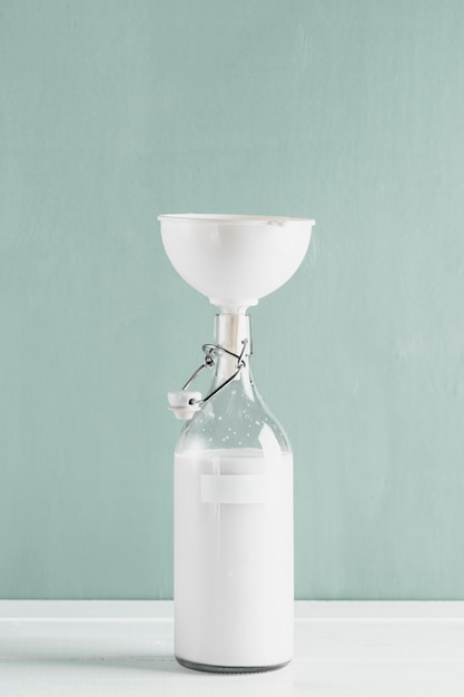 Free photo milk bottle with funnel