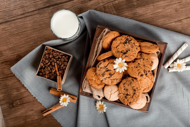 Free Photo milk, coffee box and cookies on the table.  