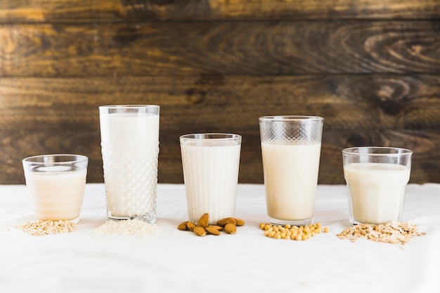 Milk in different types of glasses and cereals