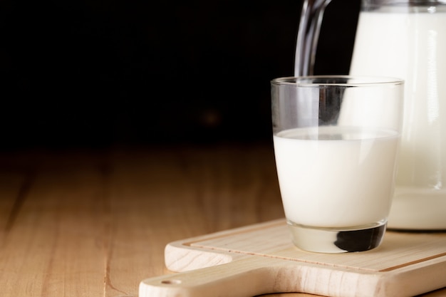 Free Photo milk in glass and jug on wooden table