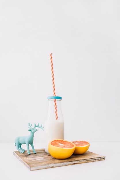 Free photo milk, grapefruit and deer toy