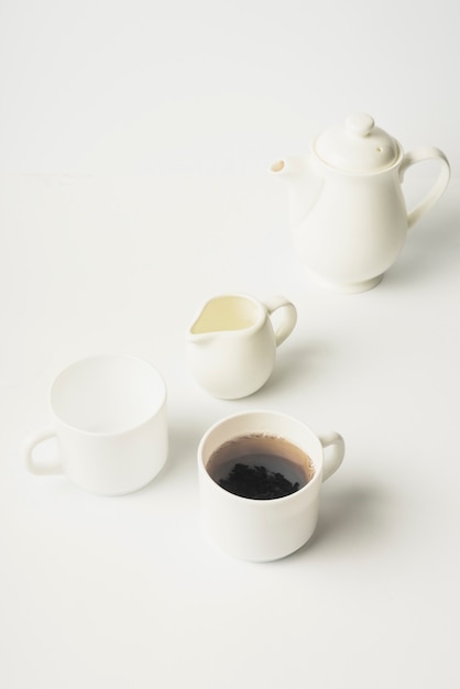 Milk pitcher; tea cup; ceramic cup and teapot on white background