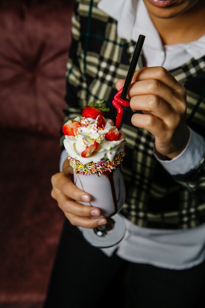 Milkshake cocktail topped with whipped cream and strawberry