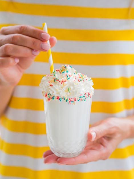 Milkshake glass with straw close-up