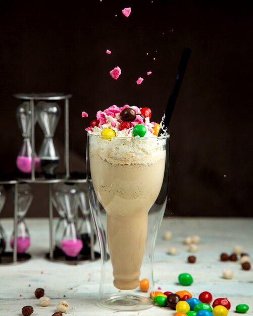 Milkshake with colorful chocolate on the table