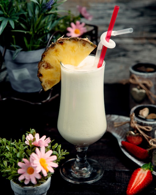 Milkshake with pineapple slice on the table