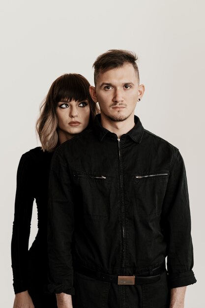 Millennial fashion couple on a white in studio