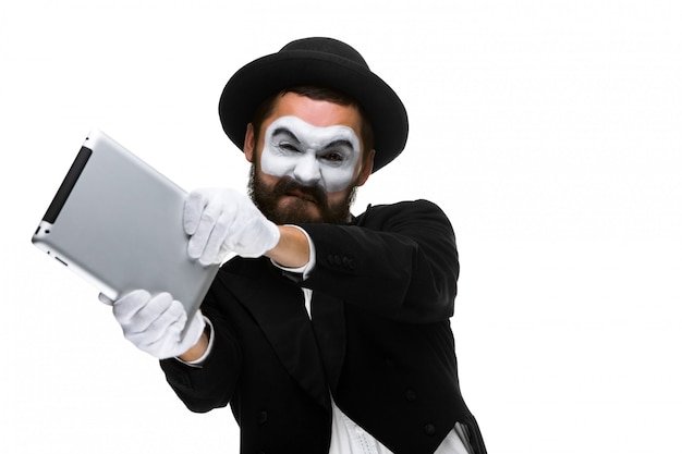 mime as a businessman throws computer in rage.