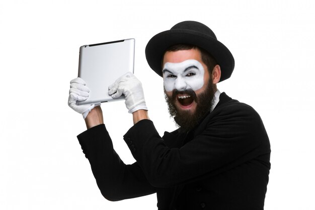 mime as a businessman throws computer in rage.