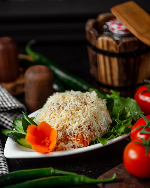 Free photo mimosa salad with ornate carrot and cucumber