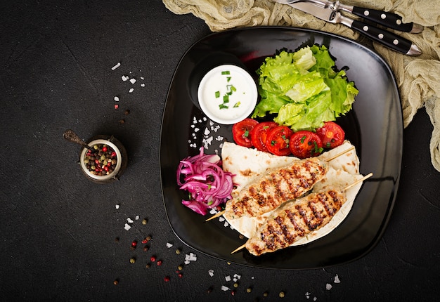 Minced Lula kebab grilled turkey (chicken) with fresh vegetables. Top view