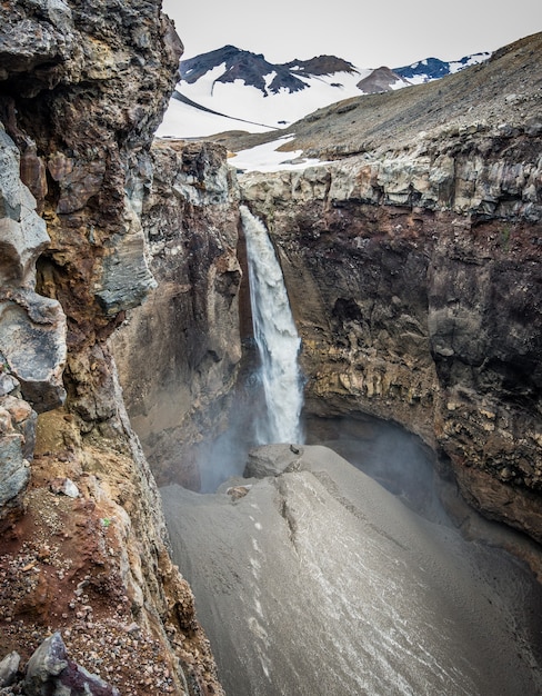 Mineral rocks and a beautiful waterfall in Kamchatka, Russia