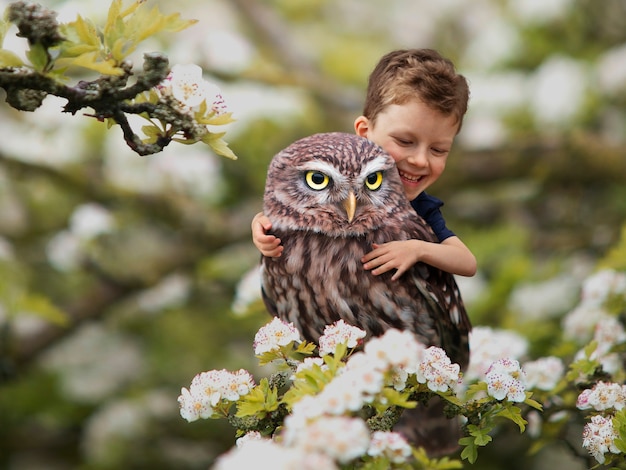 Miniature adventure with boy hugging owl