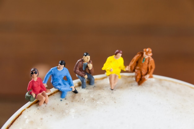 Miniature group of friends having coffee