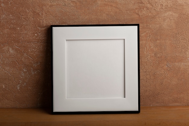 Free photo minimal empty frame with stucco background