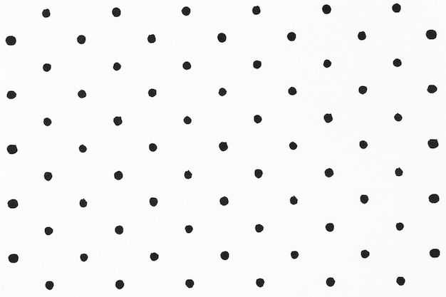 Free Photo minimal white background with black polka dot pattern