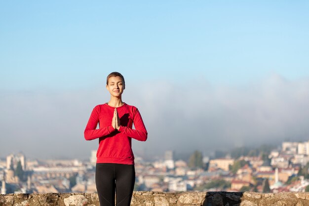 Minimal woman meditating medium shot