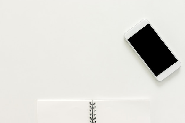 Free photo minimal work space - creative flat lay photo of workspace desk with sketchbook and mobile phone with blank screen on copy space white background. top view , flat lay photography.