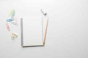 Free photo minimal work space - creative flat lay photo of workspace desk with sketchbook and wooden pencil on copy space white background. top view , flat lay photography.