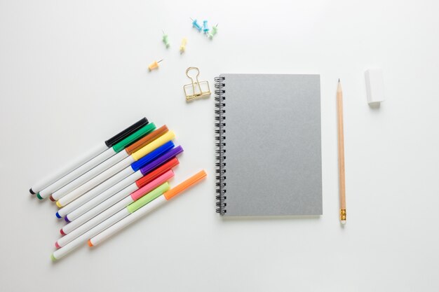 Minimal work space - Creative flat lay photo of workspace desk with sketchbook and wooden pencil on copy space white background. Top view , flat lay photography.