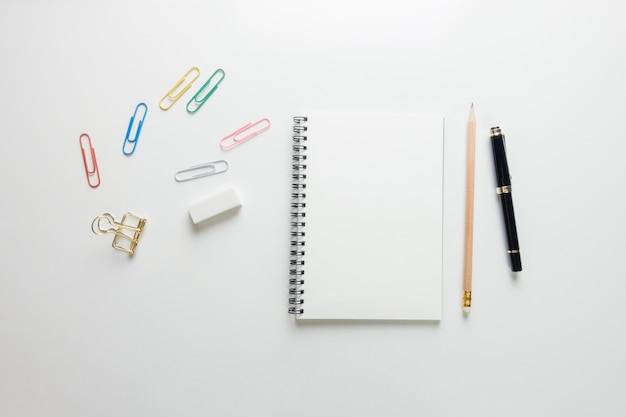 Free photo minimal work space - creative flat lay photo of workspace desk with sketchbook and wooden pencil on copy space white background. top view , flat lay photography.