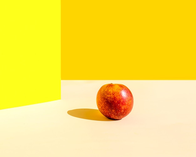 Free photo minimalist apple with shadow