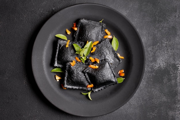 Minimalist flat lay black ravioli on plate