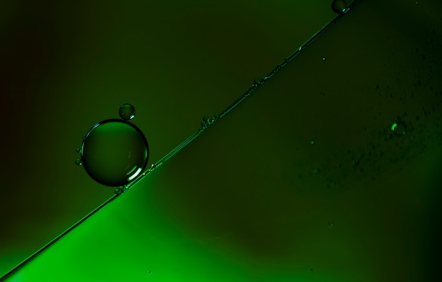 Free photo minimalist gradient green bubbles on watery surface