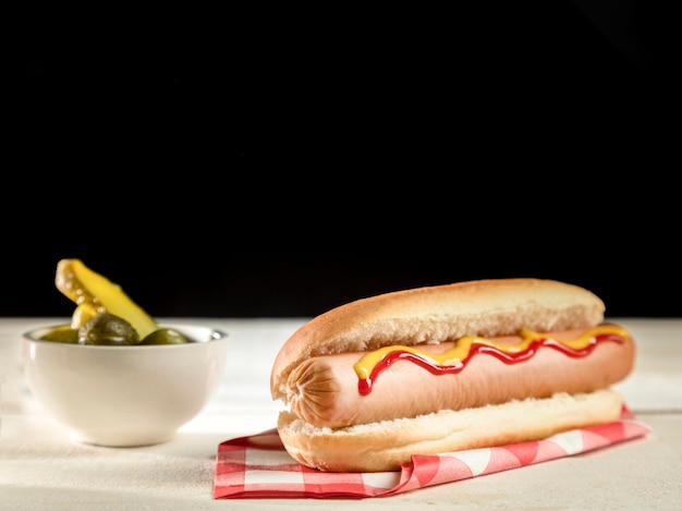 Minimalist hot dog and pickles front view