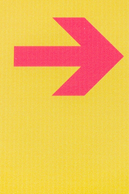 Minimalist red arrow line on yellow background and copy space